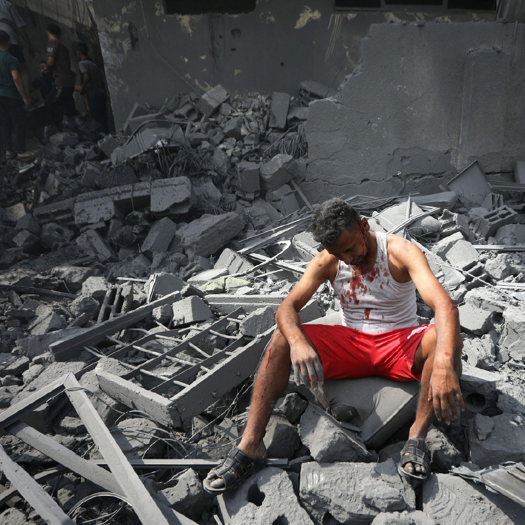Palestinian man in rubble